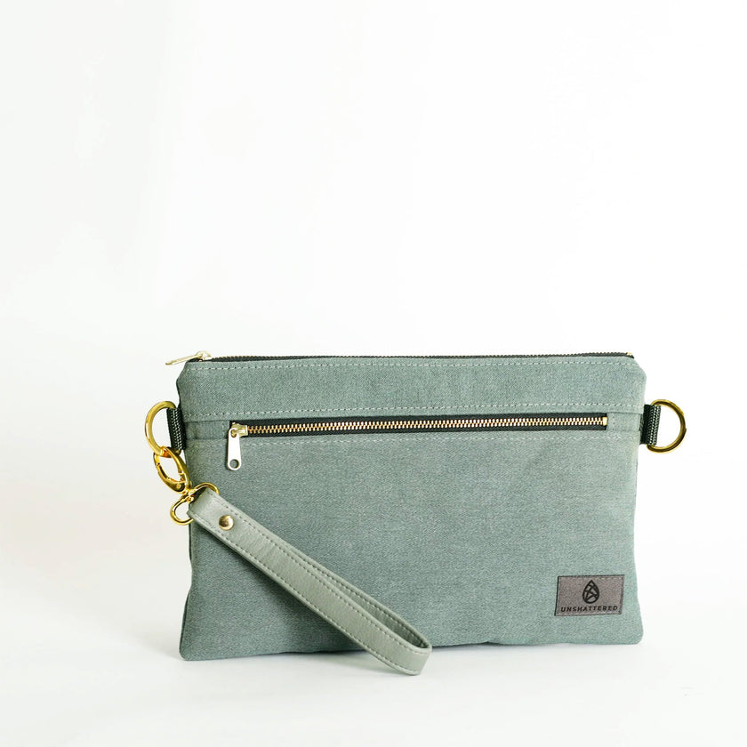 Green wristlet bag with a strap on a white background