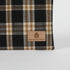 Plaid fabric with a 'Unshattered' brand label on a white background