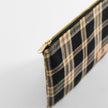 Plaid pouch with gold zipper on a light gray background