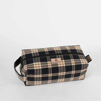 Plaid patterned toiletry bag on a light gray background