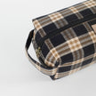Plaid patterned toiletry bag on a light gray background