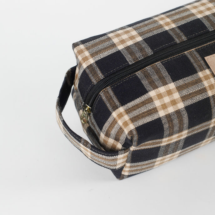Plaid patterned toiletry bag on a light gray background