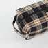 Plaid patterned toiletry bag on a light gray background