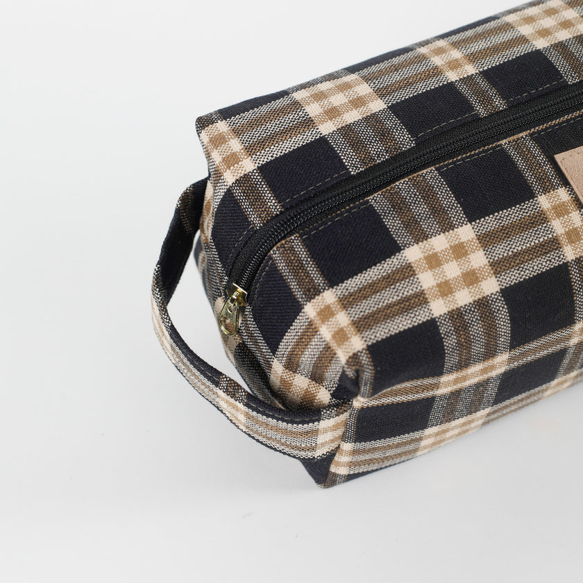 Plaid patterned toiletry bag on a light gray background