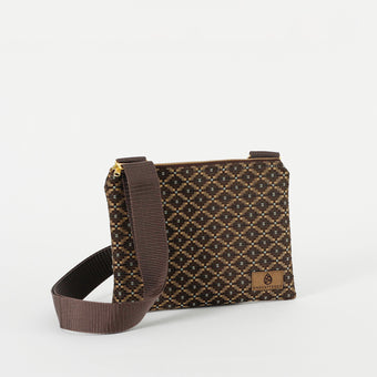 A brown and blue geometric print fabric crossbody pouch with a zipper closure and an adjustable strap.