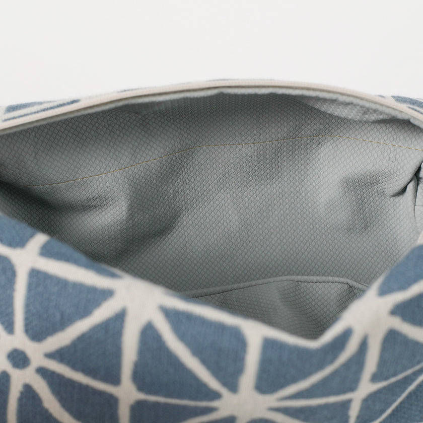 Close-up of a blue and white patterned bag with a blue interior.