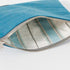 Blue fabric pouch with striped interior on a white background