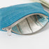 Upcycled blue pouch with a striped interior on a white background