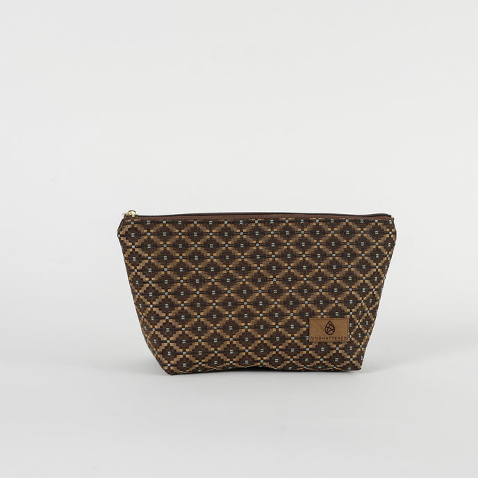 A chic makeup bag with a brown and blue geometric pattern, featuring a zipper closure and a small brand logo on the front.