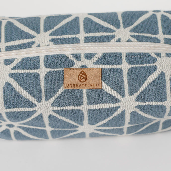 Blue and white patterned product with 'Unshattered' brand logo on a white background