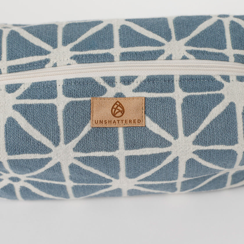 Blue and white patterned product with 'Unshattered' brand logo on a white background