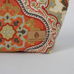 Decorative makeup bag wiith intricate pattern and 'Unshattered' brand label on a white background