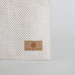 Textured fabric with a 'Unshattered' logo on a gray background