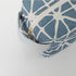 Blue and white patterned pouch with a gold zipper on a white background