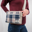 A woman wearing a blue Mercedes plaid errand bag with gray luxury leather alternative accent with silver tone hardware 