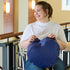 Woman holding blue heart bag made from upcycled southwest airlines seat leather 