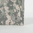 A gray Unshattered label on an upcycled army camo material 