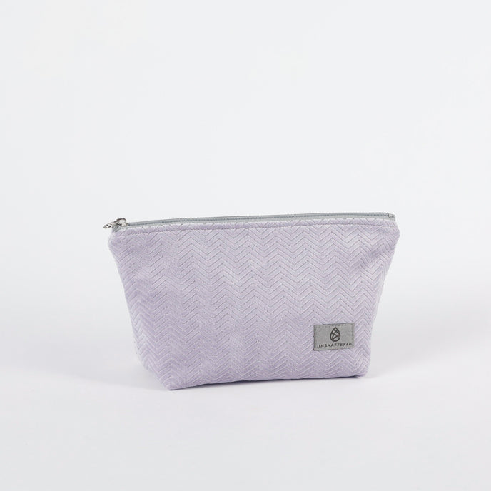 Light Purple Textured Makeup with a zipper on a white background