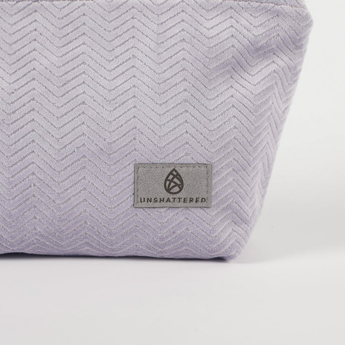 Light Purple fabric makeup kit with 'Unshattered' logo on a white background