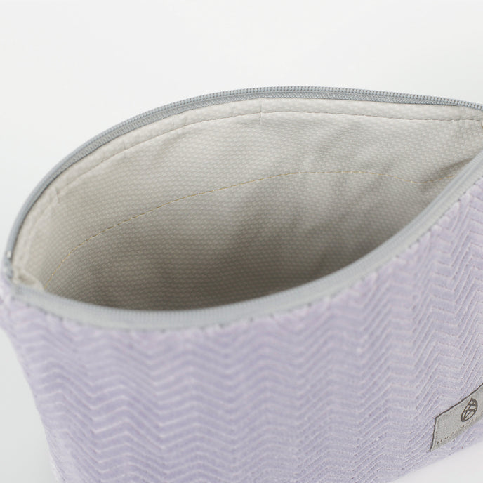 Close-up of a light gray interior  with a zipper on a white background