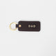 Brown leather keychain with 'DAD' engraving on a white background