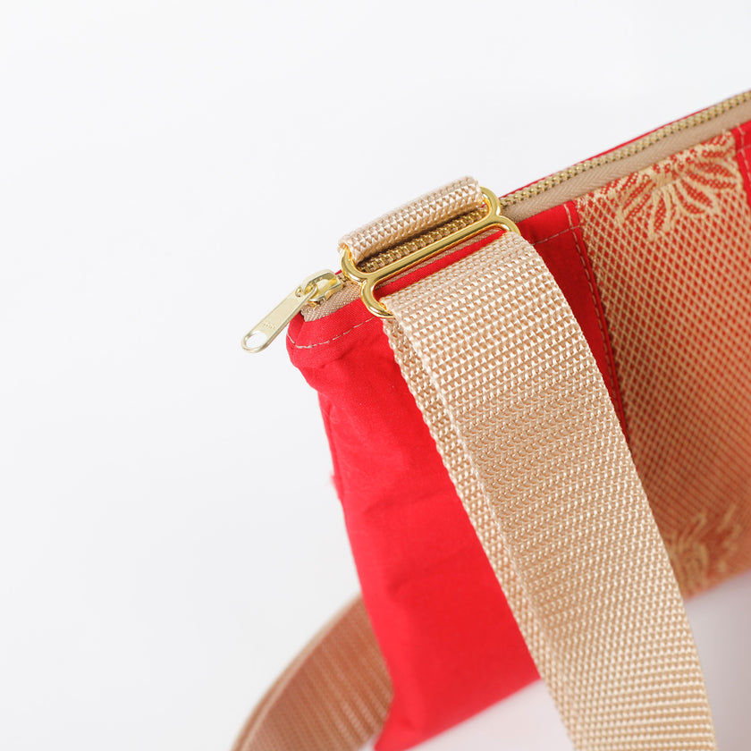 Red pouch with gold strap and zipper on a white background named after Honey 