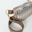 A brown strap with gold hardware on a vinyl errand bag with a brown chevron pattern named after Sally