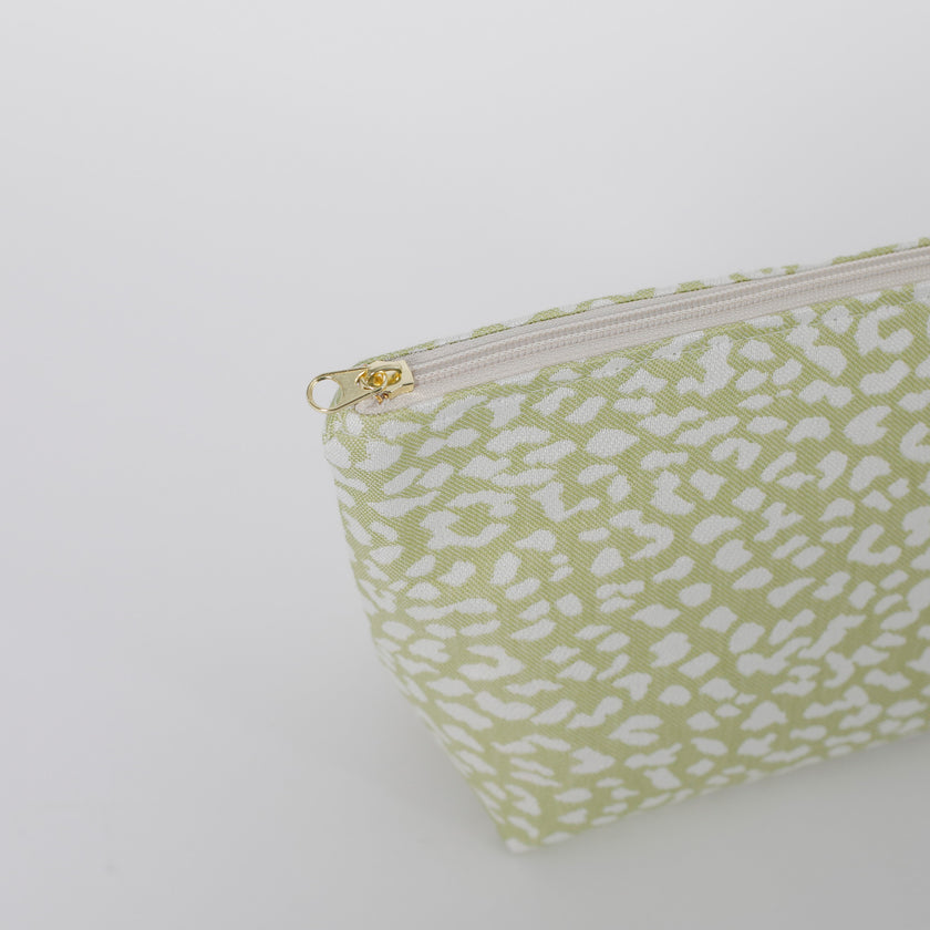Gold zipper green makeup bag with white pattern on a white  background named after Sky 