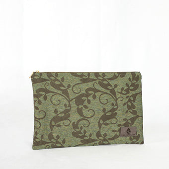 A green floral zip pouch with gold-tone hardware, closed and laid flat on a surface.