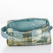 A light blue luxury leather alternative interior on a blue and green toiletry bag