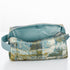 A light blue luxury leather alternative interior on a blue and green toiletry bag