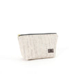A small zip closure makeup bag made of white tweed fabric with blue and gray stripes, featuring gold-tone hardware.