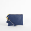 Blue anniversary wristlet with a gold tear drop clip and a tear drop keychain with a tan zipper and Unshattered emblem. 
