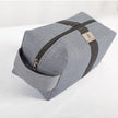 A silver tone zipper on a West Point dress gray toiletry kit 