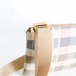 Close-up of a plaid bag with a beige strap on a white background