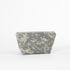 A stylish makeup kit crafted from upcycled army green fabric, featuring a durable gray zipper and a label.