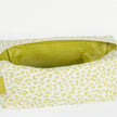 A lime green luxury leather alternative interior on a green and white print pattern toiletry kit named after Ashley 