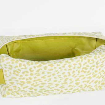 A lime green luxury leather alternative interior on a green and white print pattern toiletry kit named after Ashley 