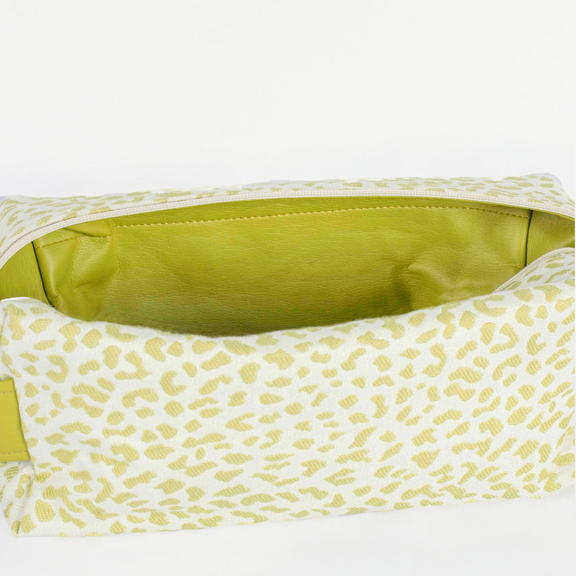A lime green luxury leather alternative interior on a green and white print pattern toiletry kit named after Ashley 