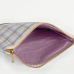 A purple fabric interior with a gold tone zipper on a purple plaid exterior named after Ashley 