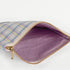 A purple fabric interior with a gold tone zipper on a purple plaid exterior named after Ashley 