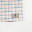 A gray label on a purple with blue, yellow and white plaid zip pouch named after Ashley 
