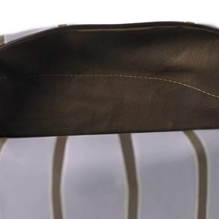 Close-up of a brown wipe-clean interior toiletry bag with a white background named after Asia 