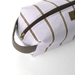 Purple toiletry bag with brown stripes and zipper partially open on a white background named after Asia 