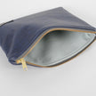 A light blue luxury leather alternative interior material with a gold seam and a gold tone zipper 