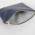 A light blue luxury leather alternative interior material with a gold seam and a gold tone zipper 