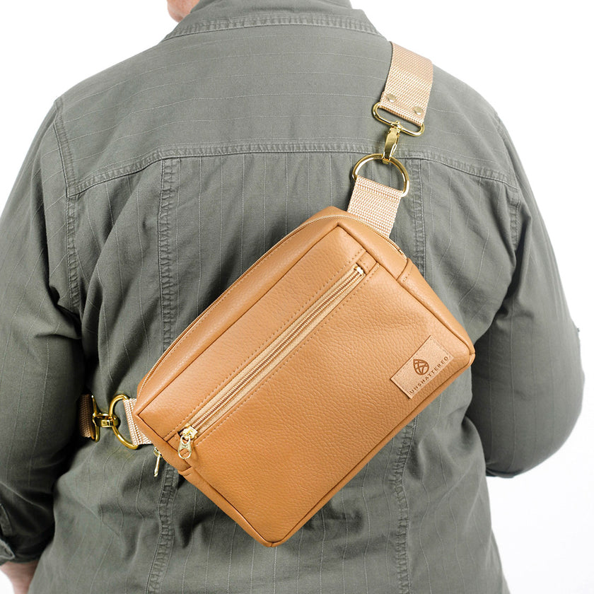 A woman wearing a camel crossbody errand bag named after Shawna 