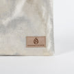 Suede tan label on an Unshattered Zip pouch named in honor of Billy