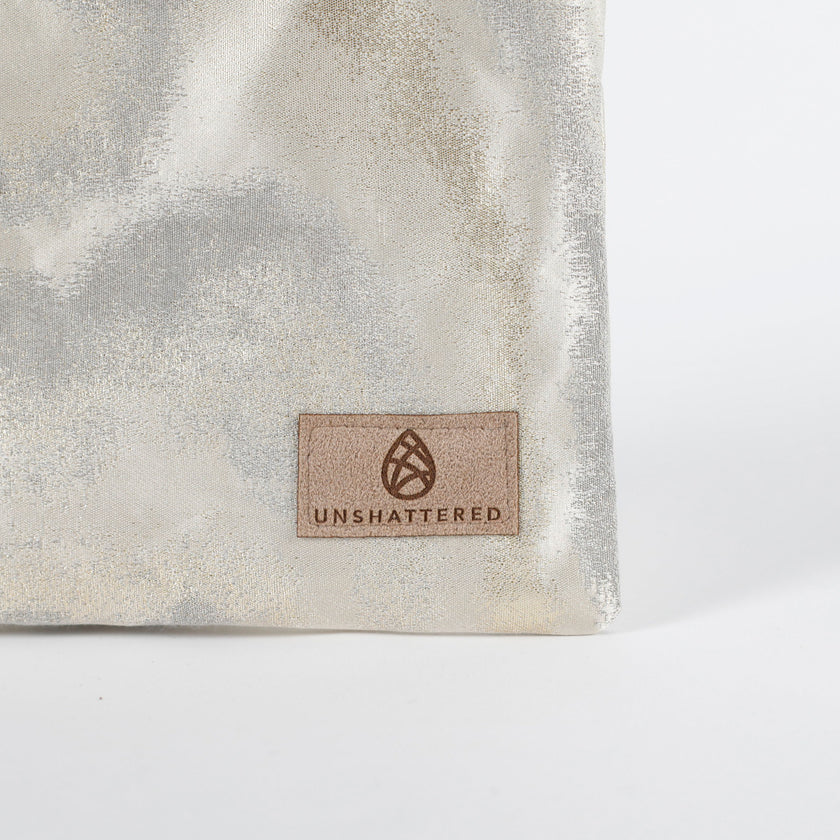Suede tan label on an Unshattered Zip pouch named in honor of Billy