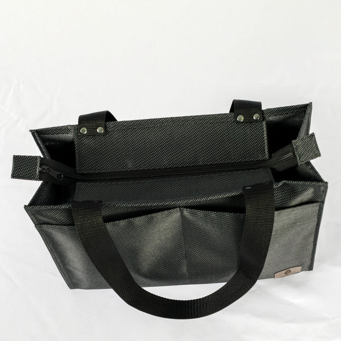 A black zippered shopper tote with.a black zipper and hardware 